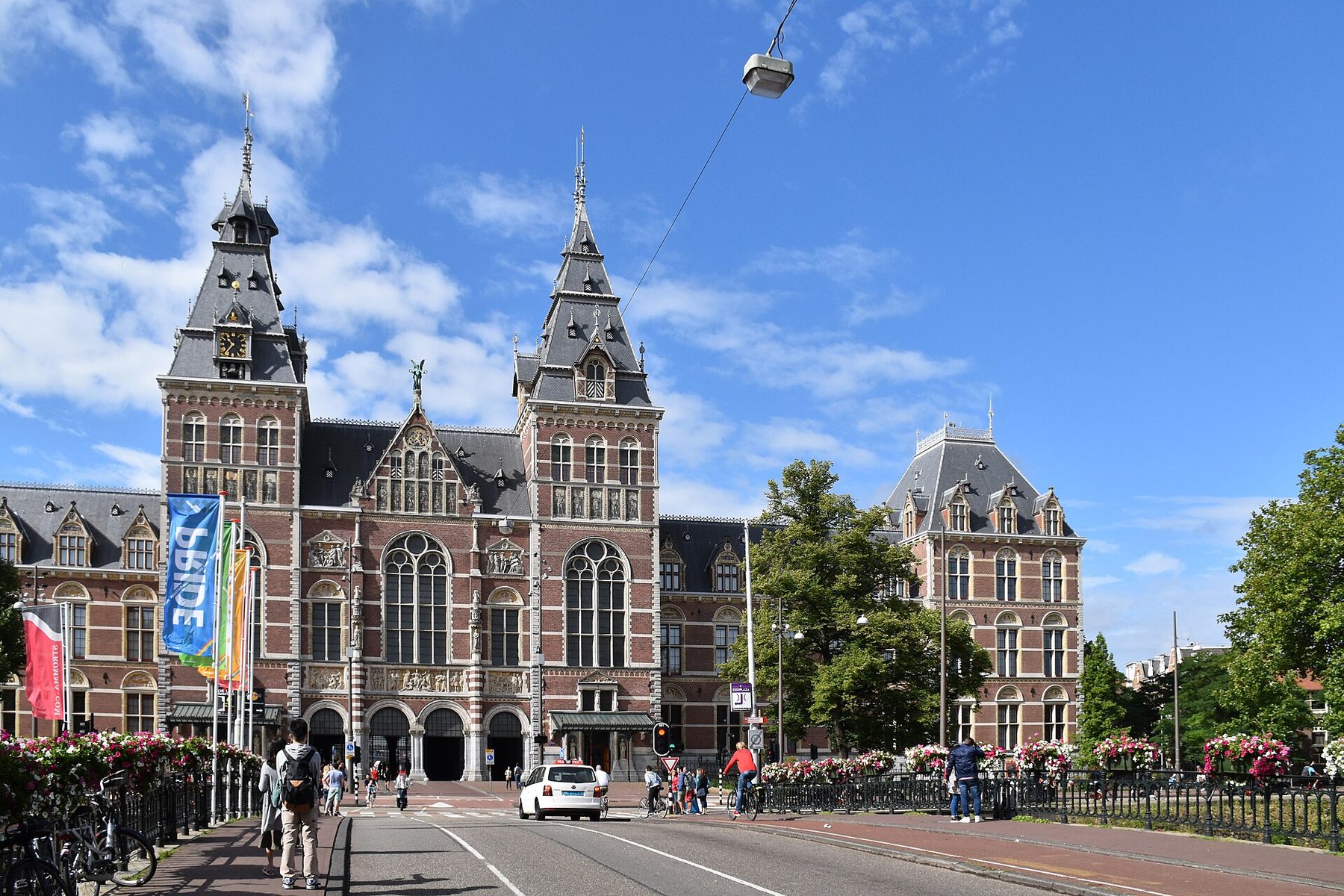 Red-brick north facade and towers of the Rijksmuseum in Amsterdam seen from the street