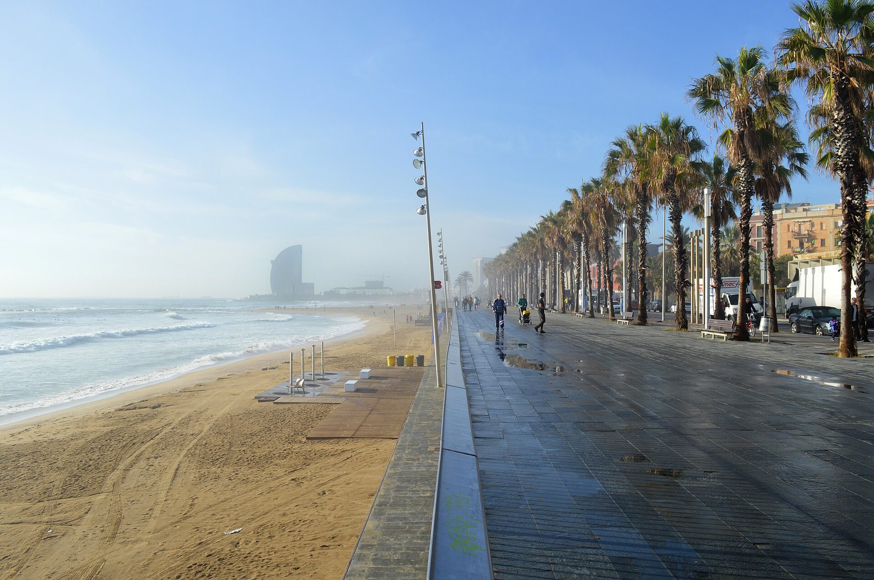 Palm-lined seafront promenade beside Platja de la Barceloneta in Barcelona