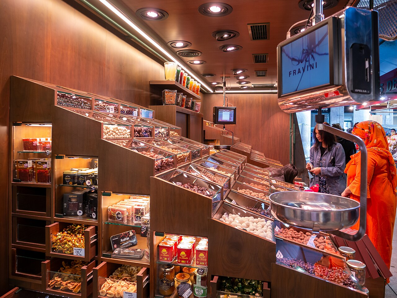 Colourful food and sweets stall inside La Boqueria market
