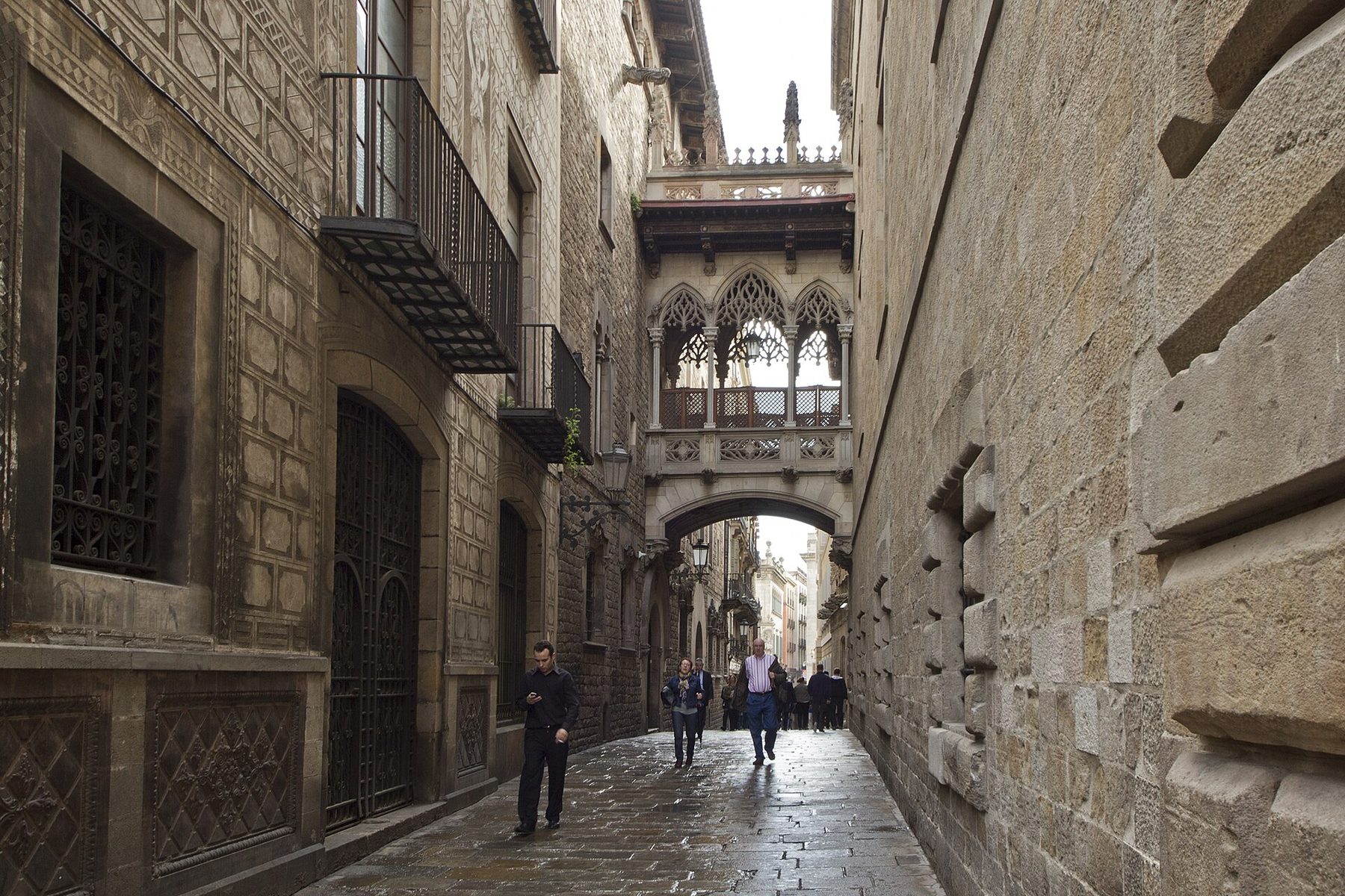 Narrow stone lane of Carrer del Bisbe with its Gothic-style bridge in Barcelona’s Gothic Quarter