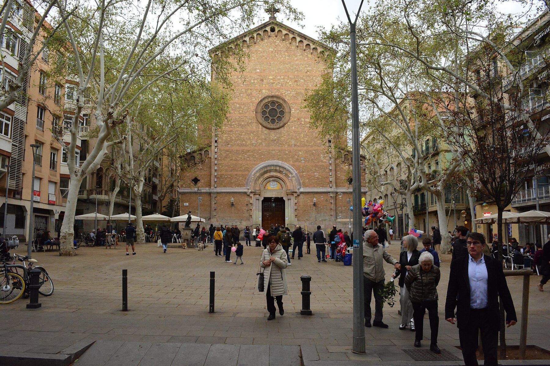 Plaça de la Virreina in Gràcia with the church of Sant Joan and café terraces under plane trees