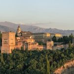 The Alhambra illuminated above Granada at dusk, seen from Mirador de San Nicolás