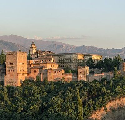 The Alhambra illuminated above Granada at dusk, seen from Mirador de San Nicolás