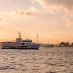 Passenger ferry crossing Istanbul's Bosphorus at sunset