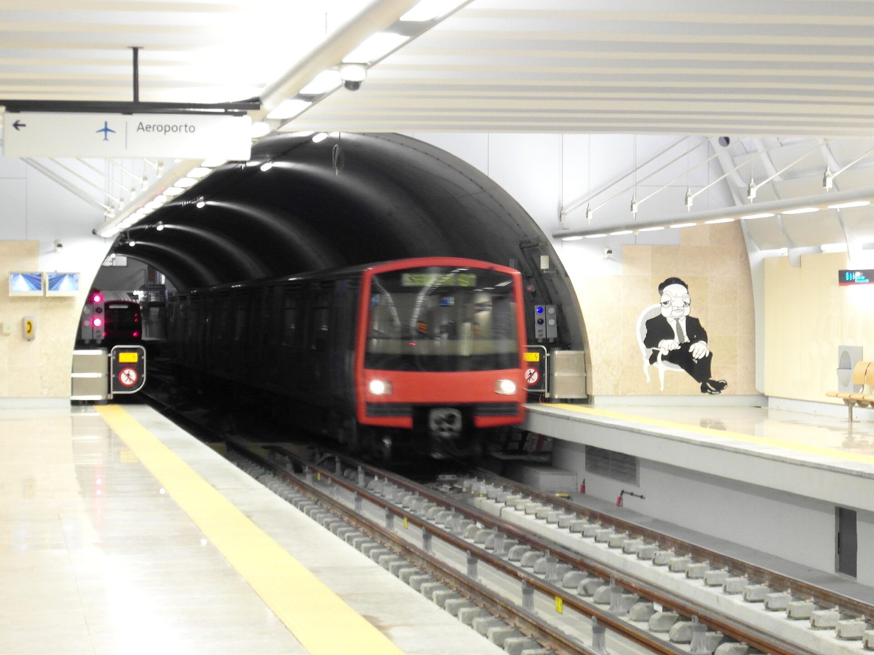 Red Line metro train arriving at the platform of Aeroporto station on the Lisbon Metro
