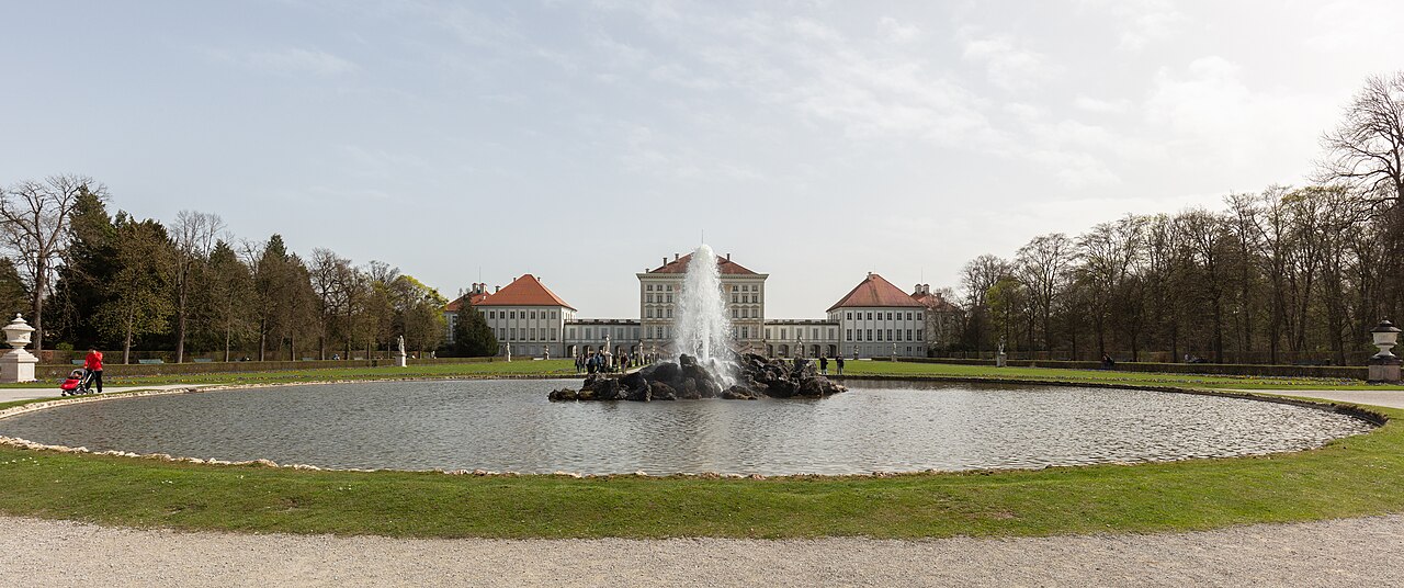 Nymphenburg Palace reflected across its garden fountain in Munich