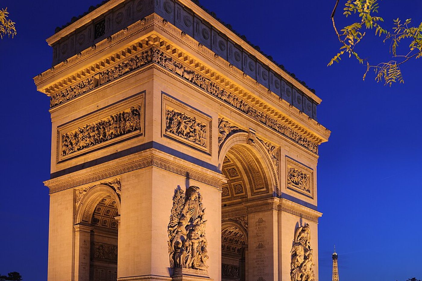 The Arc de Triomphe illuminated at night in Paris